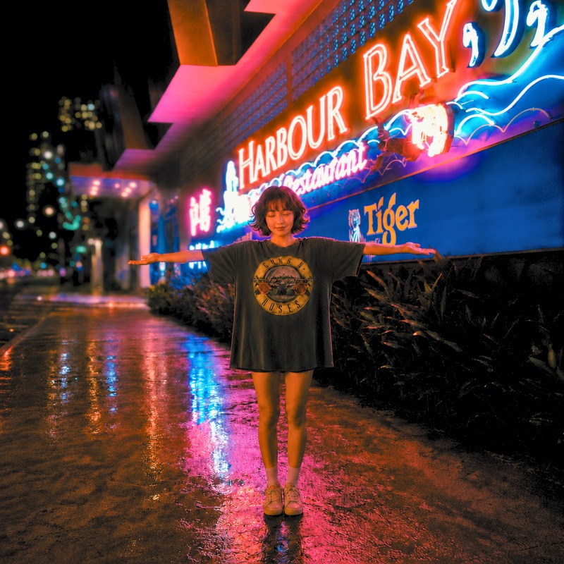Giorni Fantasista: Sounds from Harbour Bay, Volume II — woman with arms outstretched under Harbour Bay neon at night